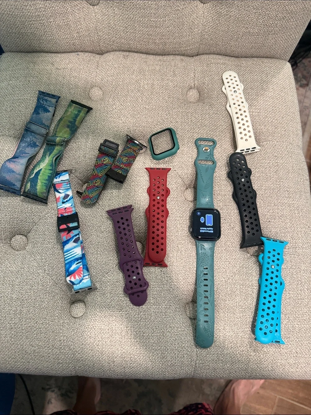 Apple Watch SE with several watch bands and an extra protective case.